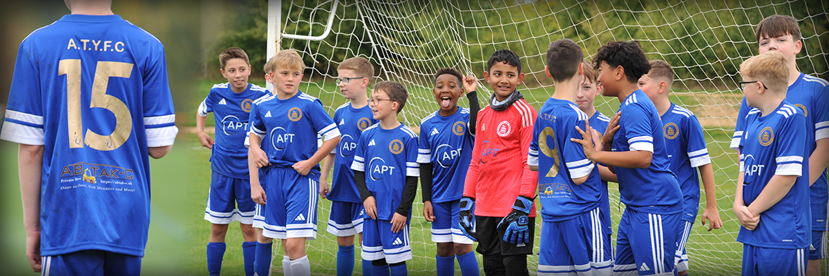 Boys in Andover town football kit sponsored by local taxi company AB Tak-C